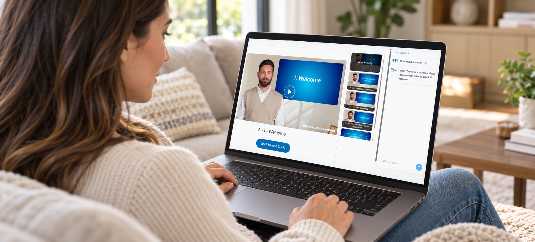 A woman exploring benefits videos and AI assistance on her laptop